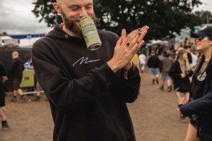 Download Festival attendee wiping his hands clean with anti-bacterial gel