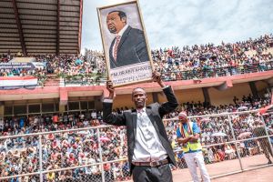 A man holds a portrait of Ethiopian Prime Minister Abiy Ahmed in a stadium in Jimma on June 16, 2021 for an electoral campaign rally.