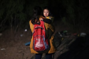 Carolina, originally from Honduras, holds her son upon arrival in the United States after crossing the Rio Grande in a raft guided by Mexican smugglers on March 28, 2021 in Roma, Texas.