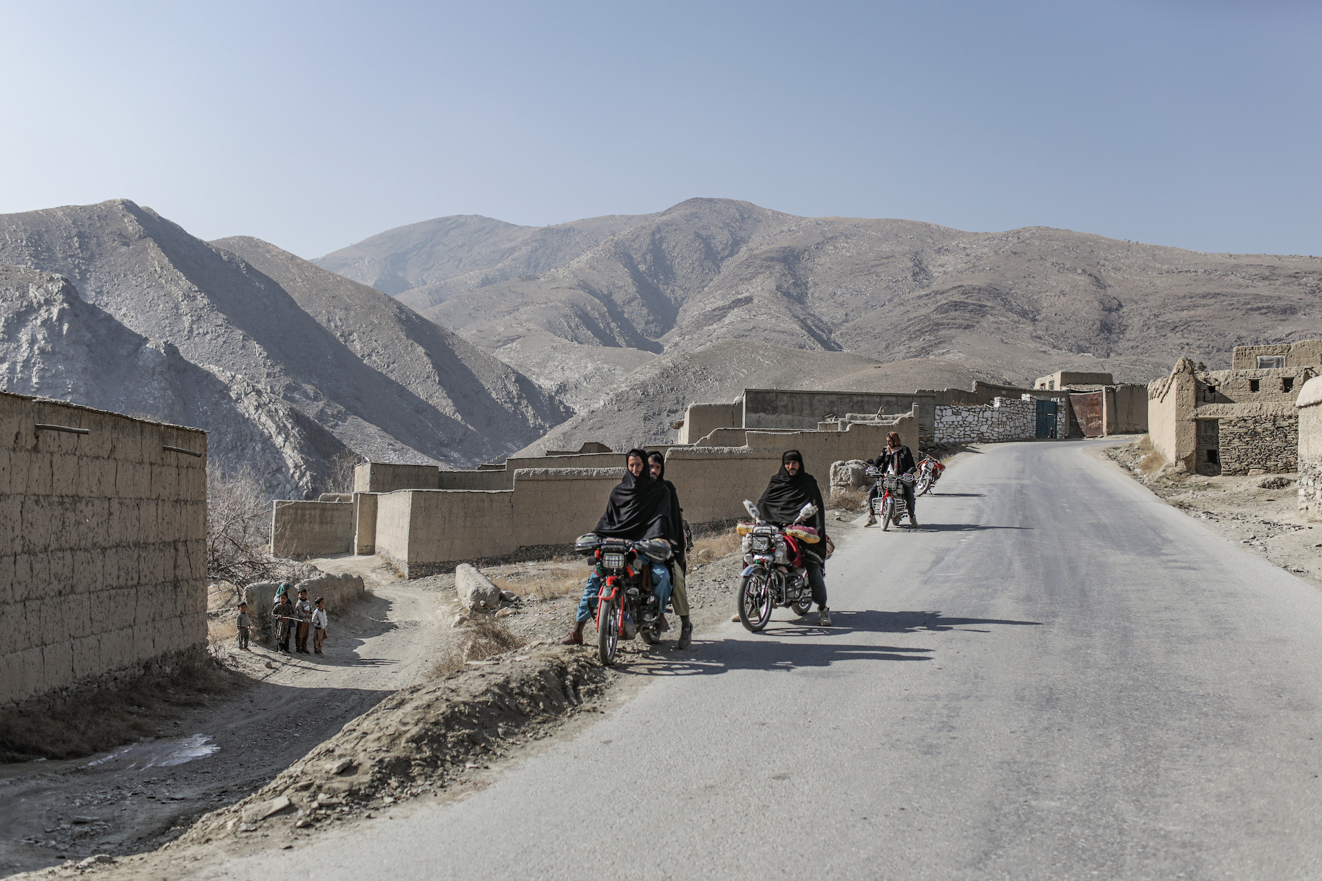 Taliban fighters on motorbikes lead the VICE News crew inside villages controlled by the group in Wardak Province. (Photo: Adam Desiderio/VICE News)