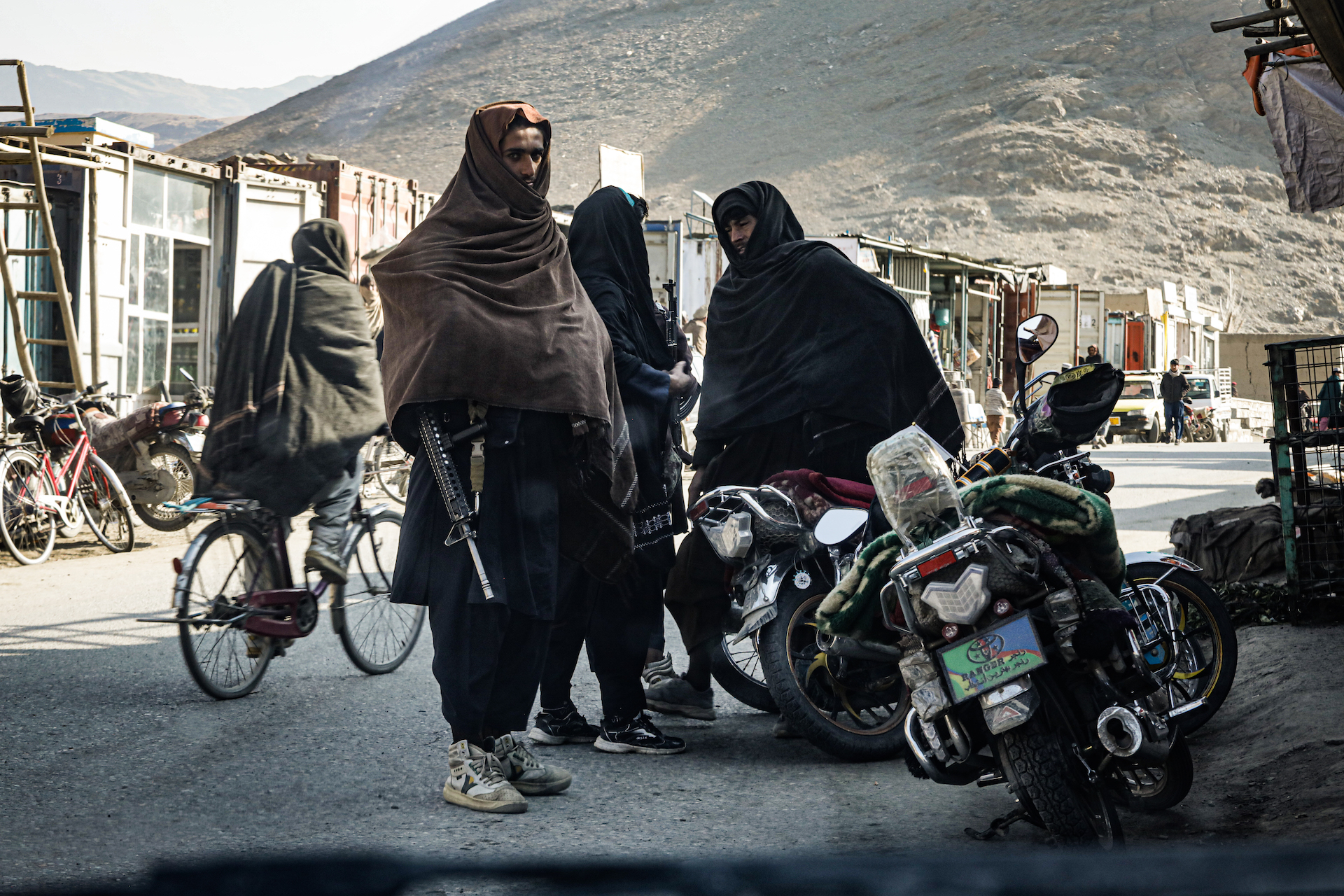 Taliban fighters on motorbikes lead the VICE News crew on a tour of the village bazaar (Photo: Adam Desiderio/VICE News)