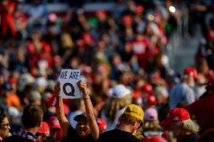 A person holds up a QAnon sign to the media as attendees wait for President Donald Trump to speak at a campaign rally at Atlantic Aviation on September 22, 2020 in Moon Township, Pennsylvania. (Jeff Swensen/Getty Images)