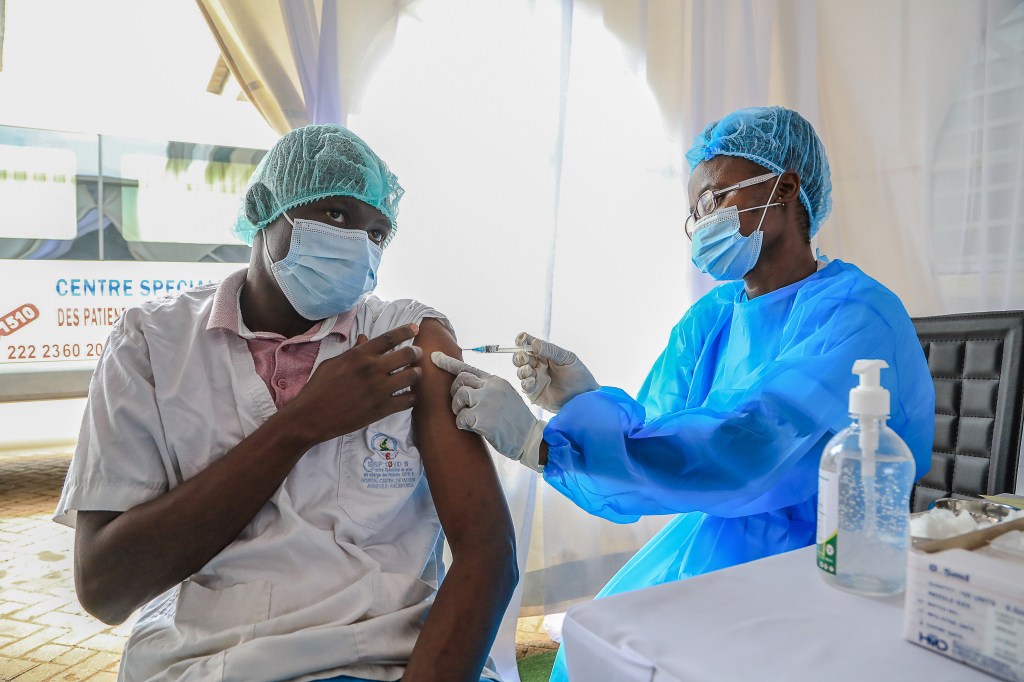 A healthcare worker receives a China's Sinopharm vaccine during the mass COVID-19 vaccination process for healthcare workers at the Central Hospital in Yaounde, Cameroon on April 12, 2021. (Stringer/Anadolu Agency via Getty Images)