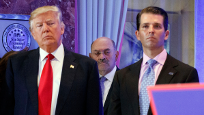 In this Jan. 11, 2017, file photo, Allen Weisselberg, center, stands between President-elect Donald Trump, left, and Donald Trump Jr., at a news conference in the lobby of Trump Tower in New York.