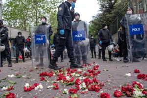 Turkish police step past carnations left by demonstrators during a May Day rally marking the international day of the worker in Istanbul, on the 1st of May 2020 Photo: by Bulent Kilic / AFP