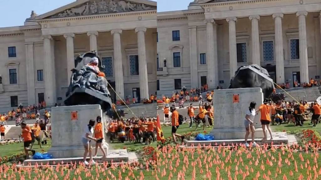 Protesters topple a statue of Queen Victoria at the Manitoba Legislature on Canada Day