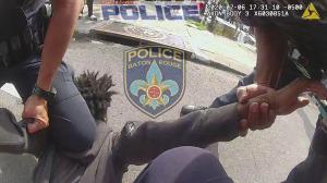 Baton Rouge police released this video screenshot of an officer placing a knee on a teenager.