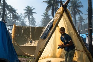 A resident from the First of May Refugee Camp dismantles his tent during the eviction process in the land in Itaguai, Rio de Janeiro, Brazil.​