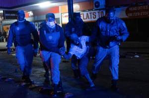 ​Police in Johannesburg​ arrest a suggested looter on the 11th of July. Photo: EMMANUEL CROSET/AFP via Getty Images