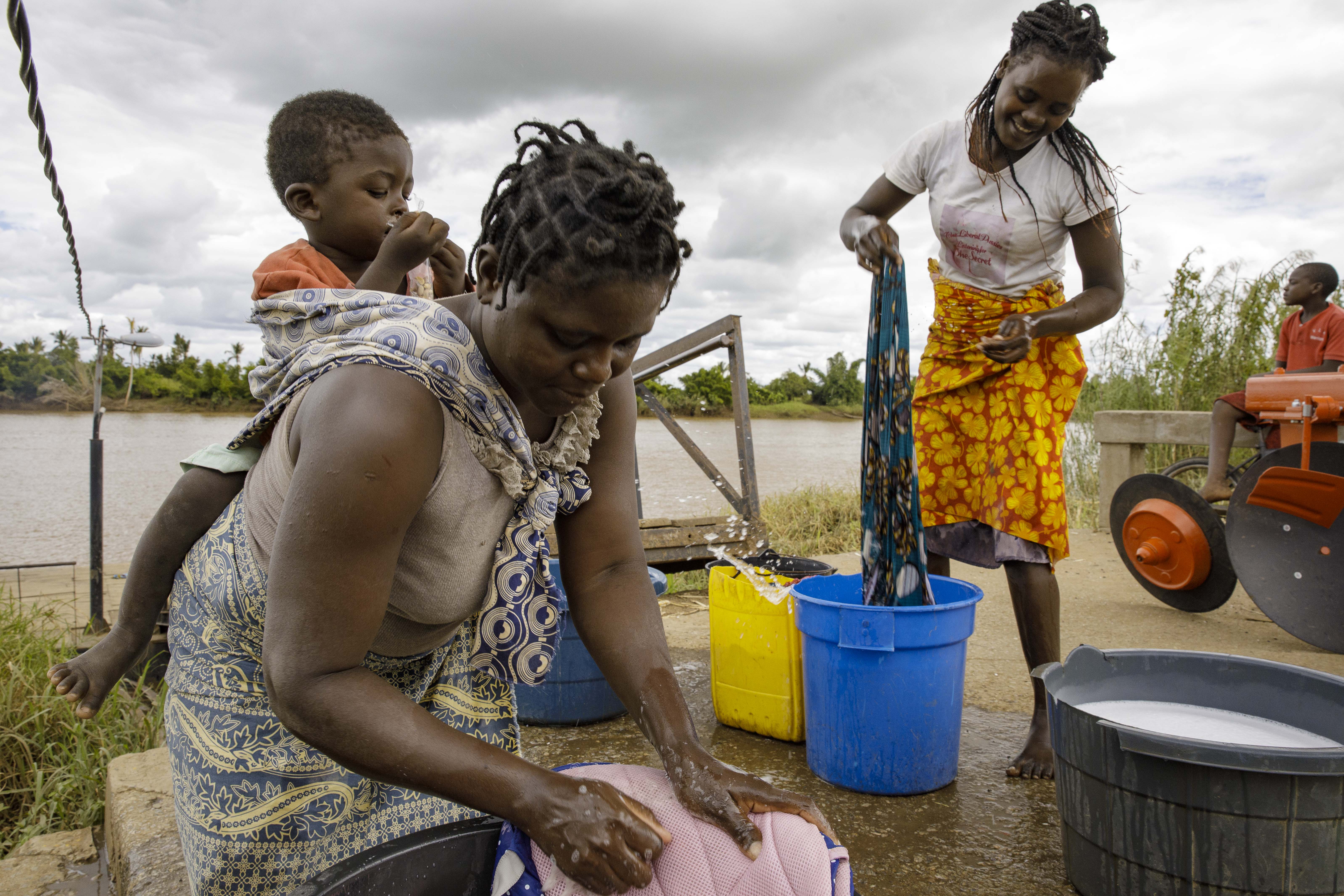 Catarina Joaquim Ukanga (Right) washes clothes on the northern bank of the river Buzi, in Buzi town, Central Mozambique.