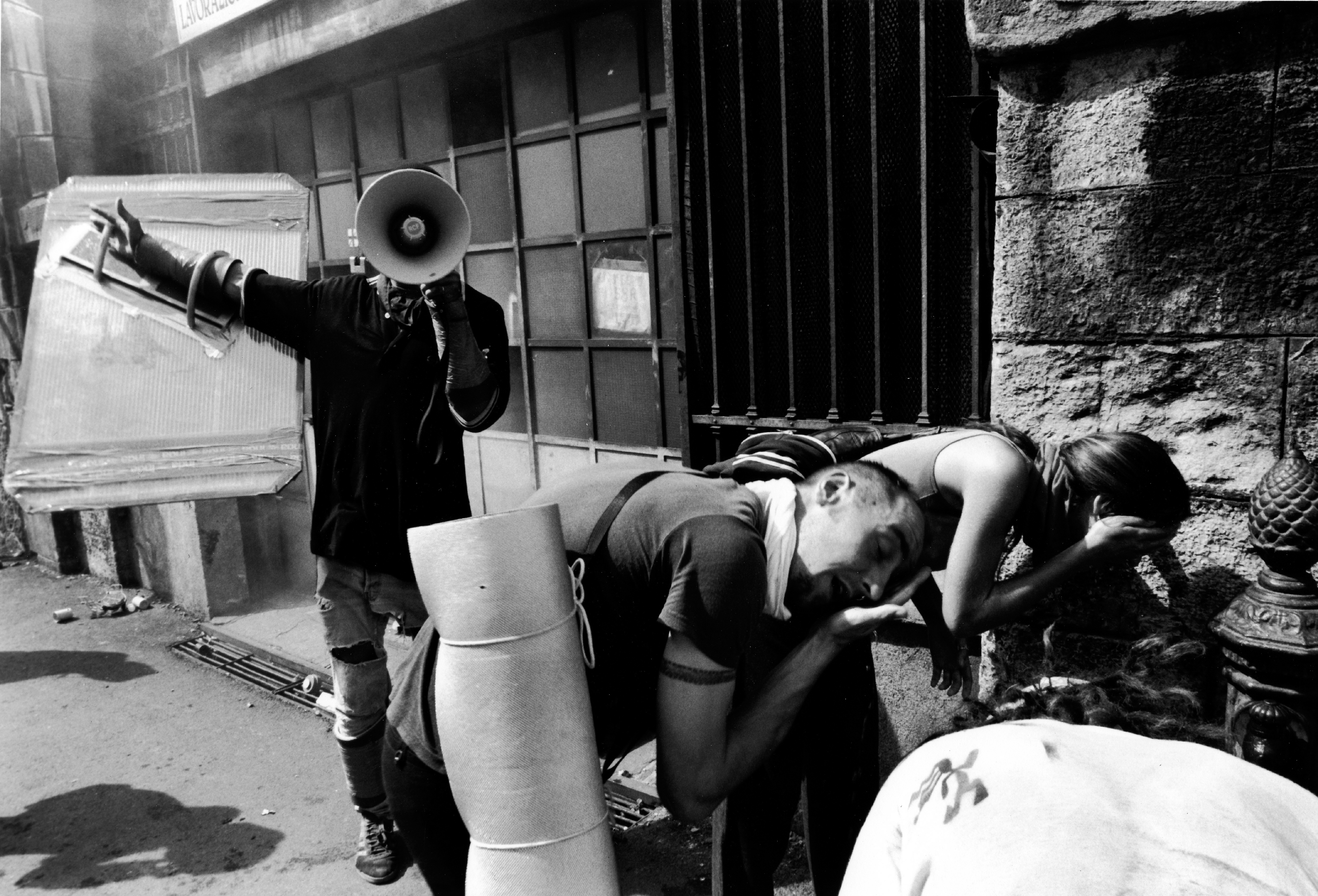 Protesters wash their eyes with water after being tear-gassed. Photo: Demonstrators gather in Genoa in July 2001. Photo: Paul BLACKMORE/RAPHO/Gamma-Rapho via Getty Images