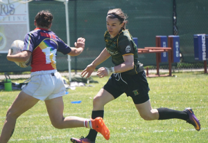 Grace Siobhan McKenzie running on a rugby pitch