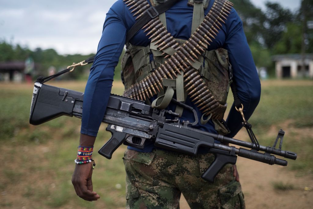 A member of the National Liberation Army (ELN) guerrilla carries his machine gun in the Choco department, Colombia, on November 19, 2017.