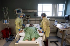 Jamie McDonough, RN, left, and Nurses Assistant Vanessa Gutierrez, check on a COVID-19 patient in the COVID ICU at St. Joseph Hospital in Orange, CA on Wednesday, July 21, 2021. (Paul Bersebach/MediaNews Group/Orange County Register via Getty Images)​