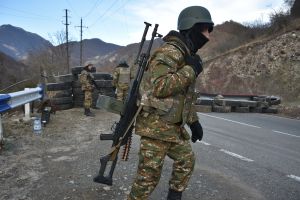 An Armenian soldier stands guard at a checkpoint of the demarcation line on the road to Kalbajar near the village of Charektar on November 25, 2020. ​