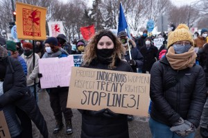 Line 3 protester holds a sign urging people to protect Indigenous women from the pipeline project