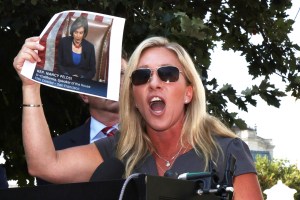 U.S. Rep. Marjorie Taylor Greene (R-GA) holds up a picture of Speaker of the House Rep. Nancy Pelosi (D-C) as she speaks during a news conference outside U.S. Supreme Court on July 27, 2021 in Washington, DC. (Alex Wong/Getty Images)​