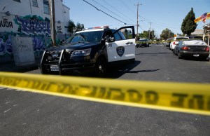 A police car behind yellow caution tape