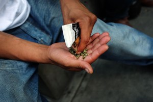 A man prepares to smoke K2 or "Spice", a synthetic marijuana drug.