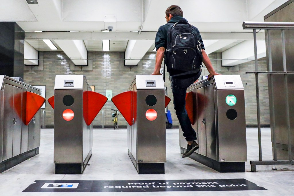 A man jumps the turnstile at the BART station at San Francisco's Civic Center on Thursday, Aug. 16, 2018.