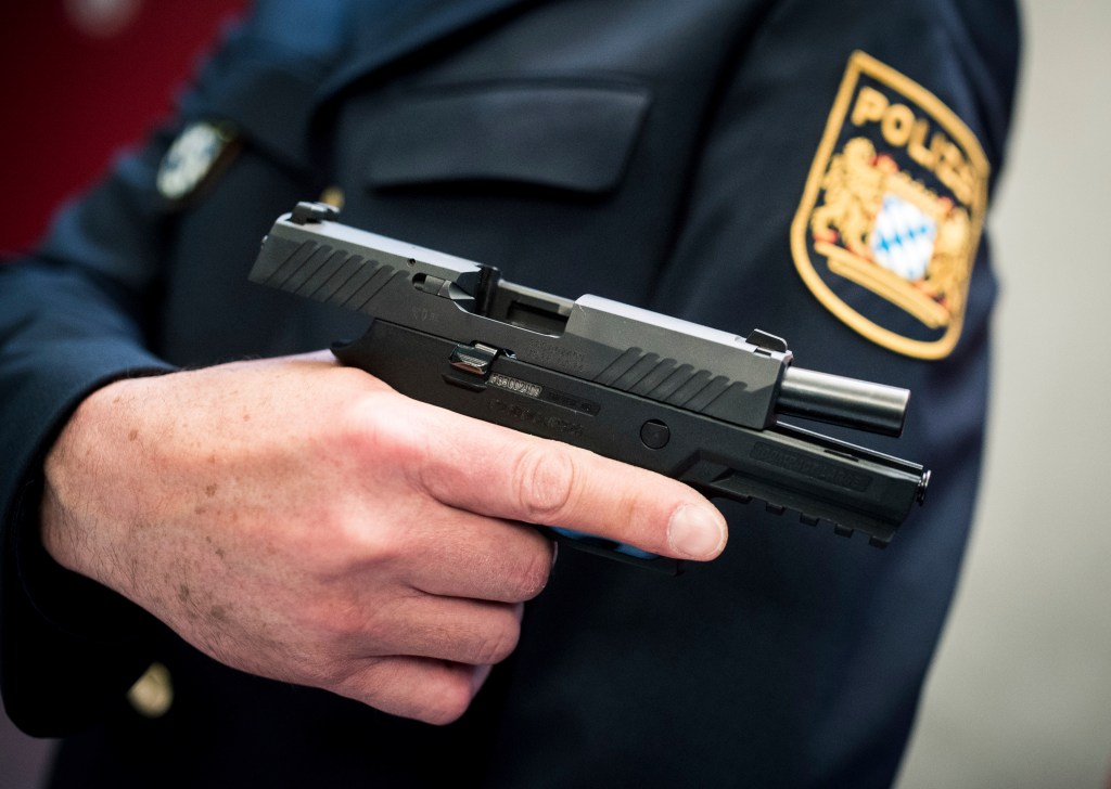 A police officer presents the possible new service weapon Sig Sauer P320 in Munich, Germany, 5 April 2017.