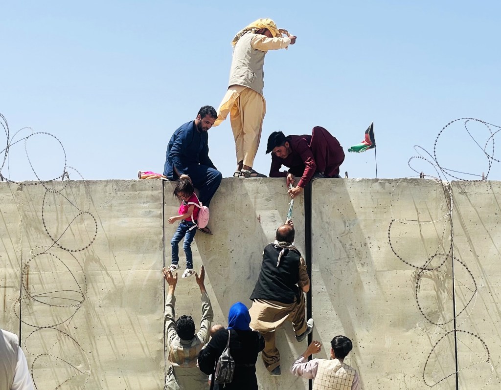 Thousands of Afghans rush to the Hamid Karzai International Airport as they try to flee the Afghan capital of Kabul, Afghanistan, on August 16, 2021.