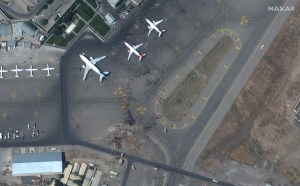 A satellite image shows people standing on runways at Kabul airport. Photo: Satellite image ©2021 Maxar Technologies.