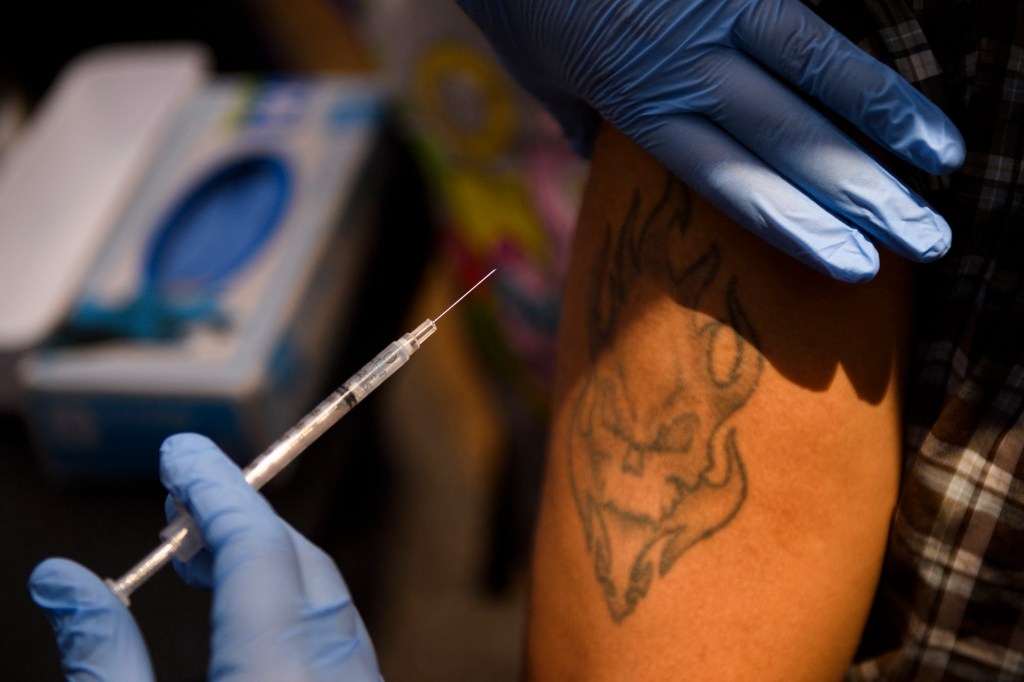 A person receives a first dose of the Pfizer Covid-19 vaccine at a mobile vaccination clinic on August 7, 2021.