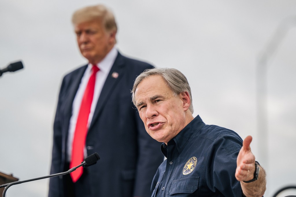 Texas Gov. Greg Abbott speaks alongside former President Donald Trump during a tour to an unfinished section of the border wall on June 30, 2021 in Pharr, Texas.