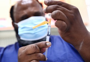 A COVID-19 vaccination dose is prepared in Bordelon's Pharmacy as part of a vaccination campaign organized by nurse Carla Brown on August 17, 2021 in Baton Rouge, Louisiana.