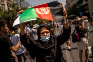 Afghan woman; flag; protest