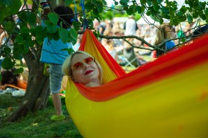 Woman smiling in hammock at a festival