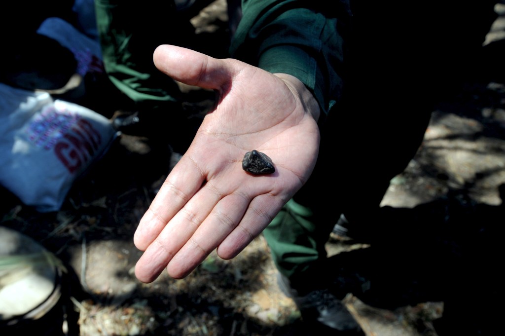 A member of the Venezuelan army displays a nugget of coltan