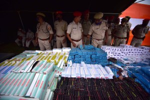 Police display drugs seized from different operations in July 2021, before burning them in Nagaon District of Assam, India.