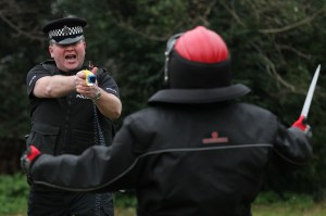 A police officer demonstrates the use of a Taser during a media conference at police headquarters in Sussex, England. Photo: Gareth Fuller/PA Images via Getty Images