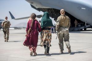 ​Afghan refugees boarding a US airforce plane at Kabul airport to evacuate the country. Photo: Planetpix/Alamy Live News