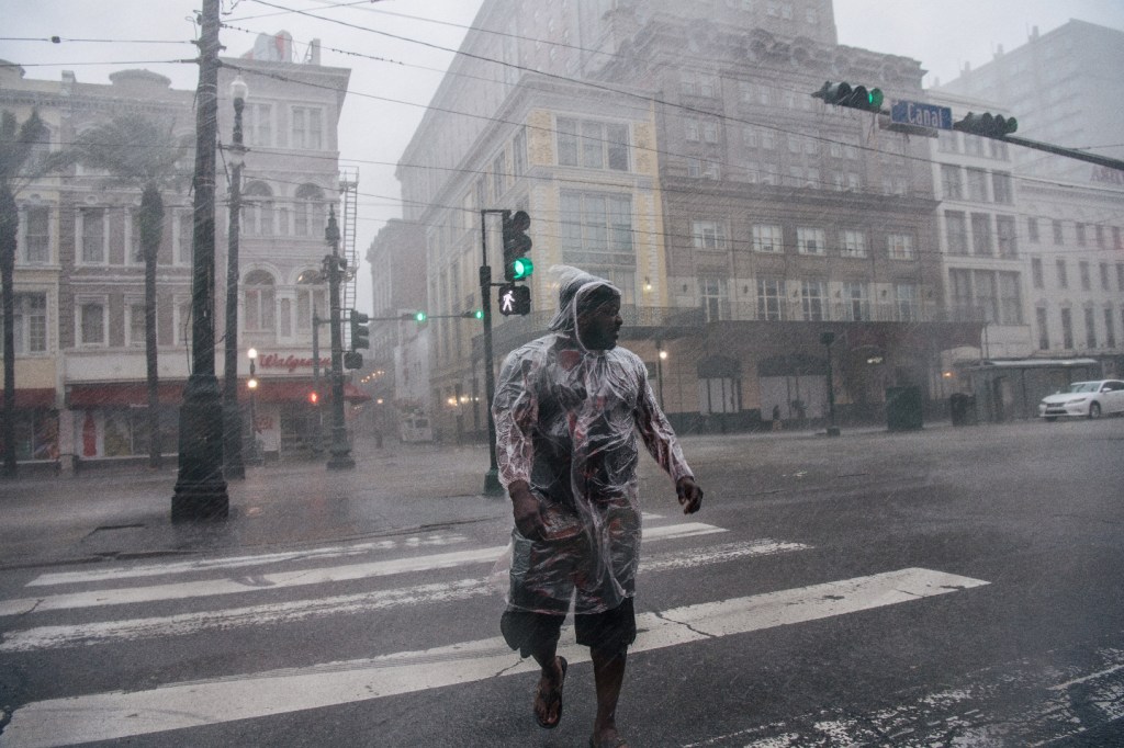 A person crosses the street during Hurricane Ida on August 29, 2021 in New Orleans, Louisiana. The hurricane made landfall earlier today and continues to cut across Louisiana. Hurricane Ida has been classified as a Category 4 storm with winds of 150 mph.