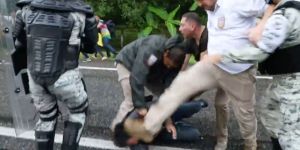 A screenshot from a video that shows an immigration official stomping on the head of a Central American migrant in southern Mexico over the weekend.