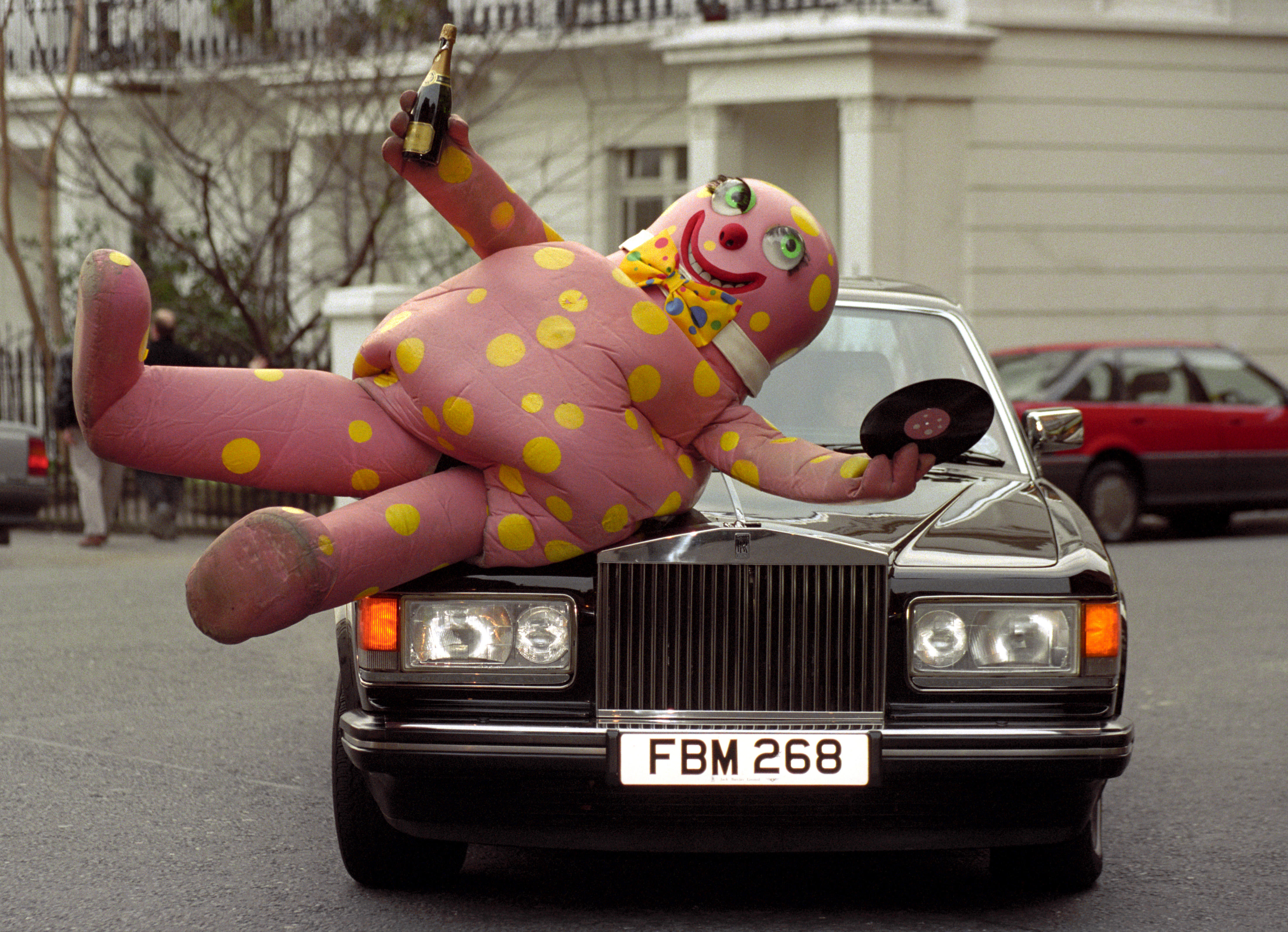 Mr Blobby lying across a Porsche celebrating his hit single