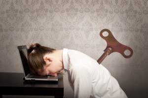 Woman face plants onto her laptop with wind up toy key in her back.