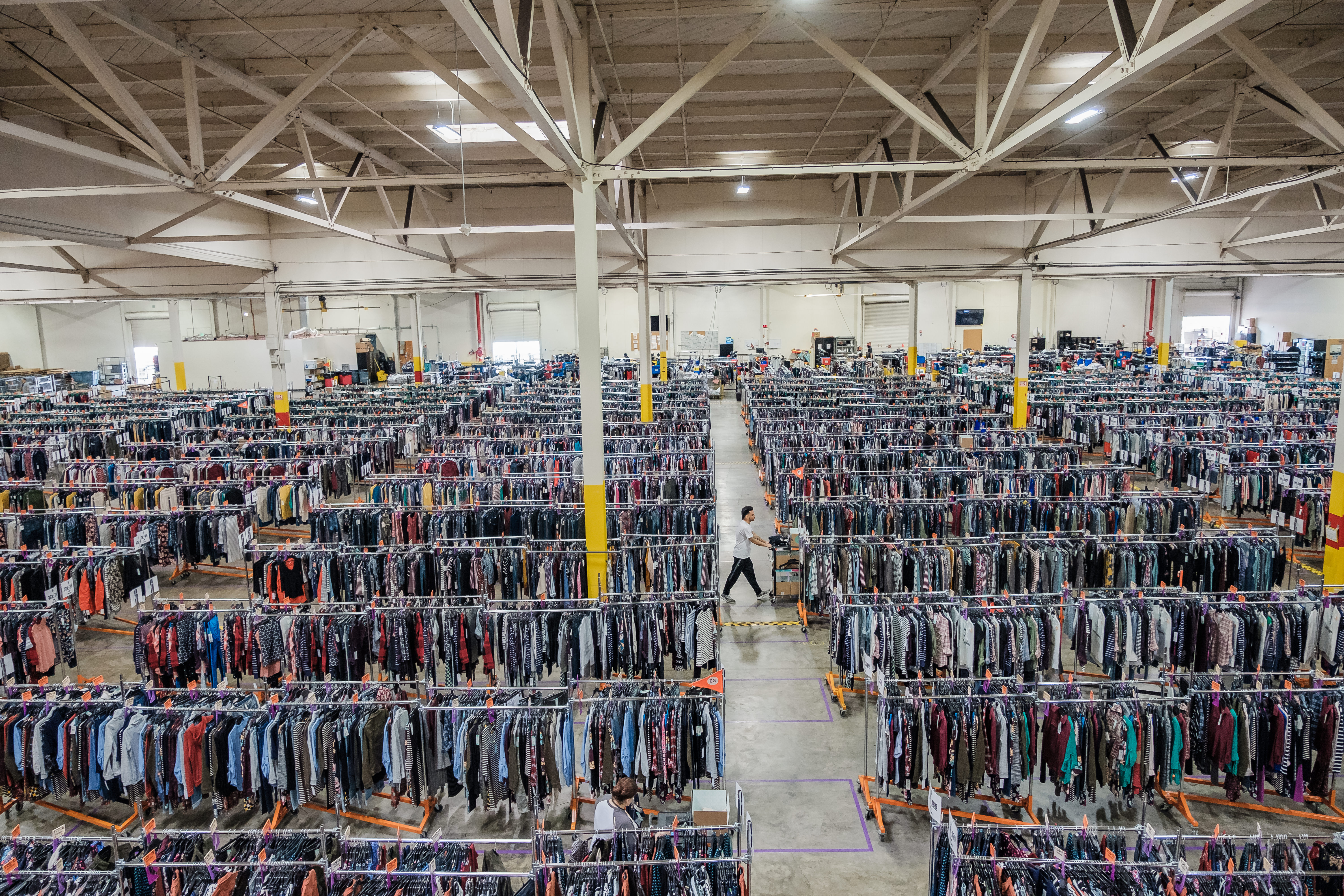 An employee can be seen pulling clothes at one Stitch Fix's warehouses, in South San Francisco