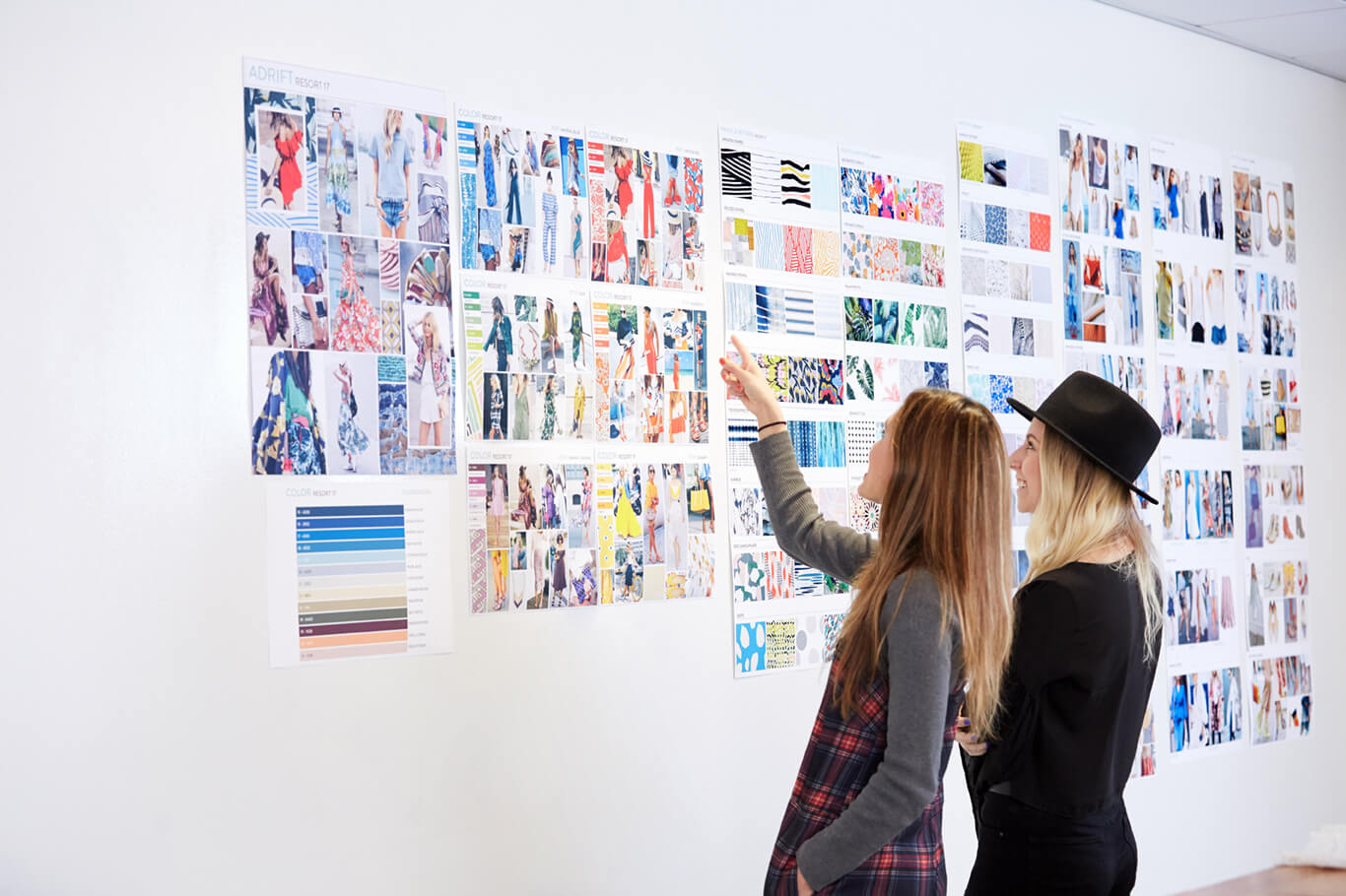 Two women pointing at a style board at the Stich Fix headquarters.