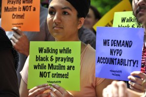 Demonstrators listen at a press conference outside One Police Plaza in New York to discuss planned legal action challenging the police department’s surveillance of businesses frequented by Muslim residents and mosques, June 18, 2013.  (Photo credit: TIMOT