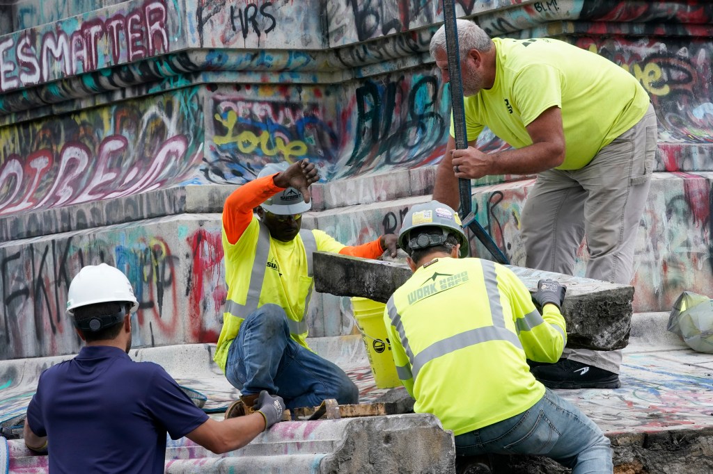 Crews dismantle the corner of the pedestal of the Robert E. Lee statue as they attempt to locate a time capsule thought to be buried in the base on Monument Avenue in Richmond, Va., Thursday, Sept. 9, 2021. The statue was removed from the pedestal Sept. 8