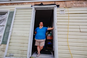 Monica Redman, 58, the tribal roll coordinator for the United Houma Nation, stands in the doorway of her trailer in Houma, Louisiana, on Sept. 19, 2021. Redman’s home slid off its posts during Hurricane Ida and sustained significant damage, including mold