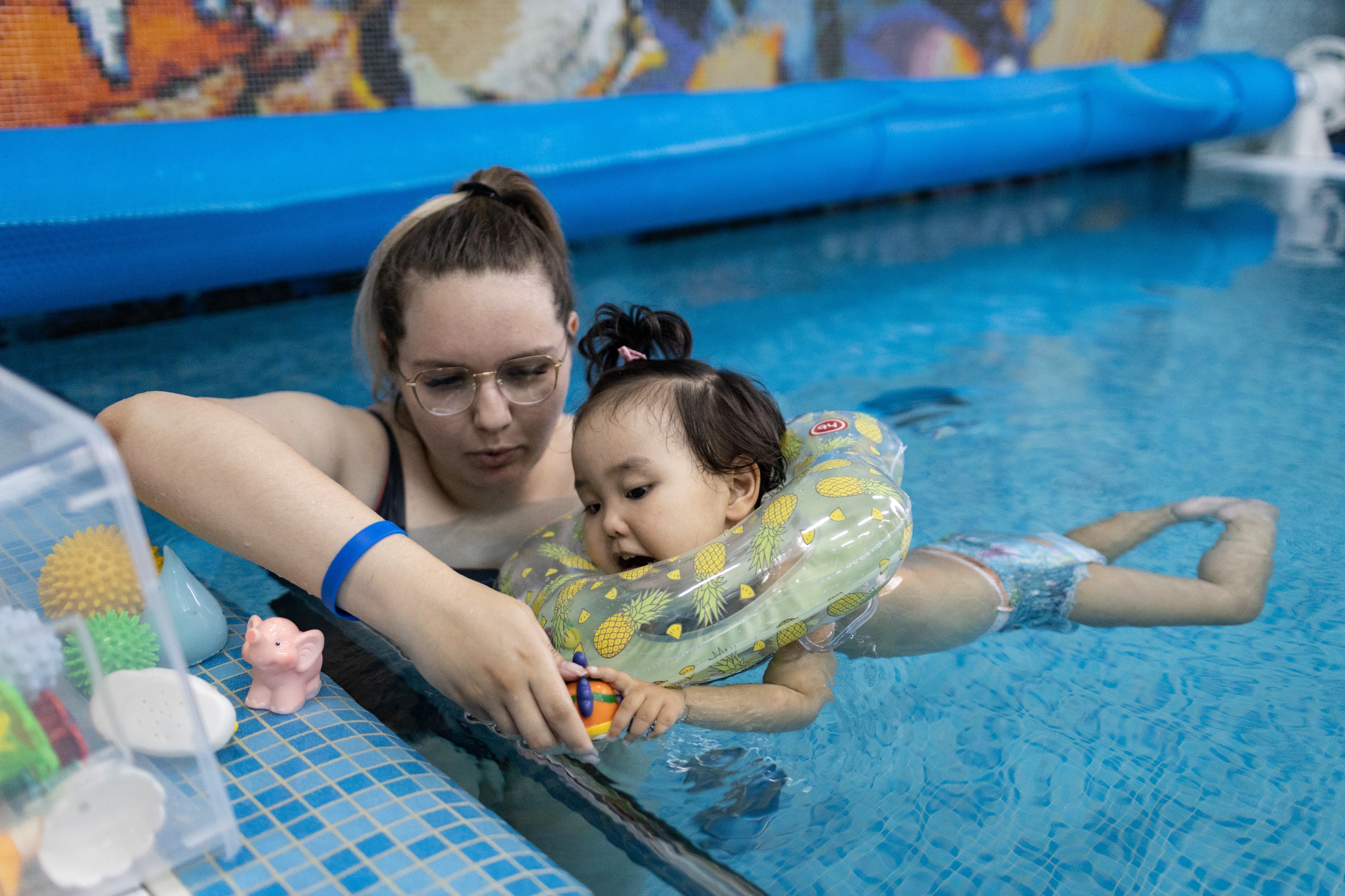 A VOLUNTEER SWIMS WITH A LITTLE GIRL IN A SWIMMING POOL AT THE LIGHTHOUSE CHILDREN’S HOSPICE IN MOSCOW, RUSSIA.