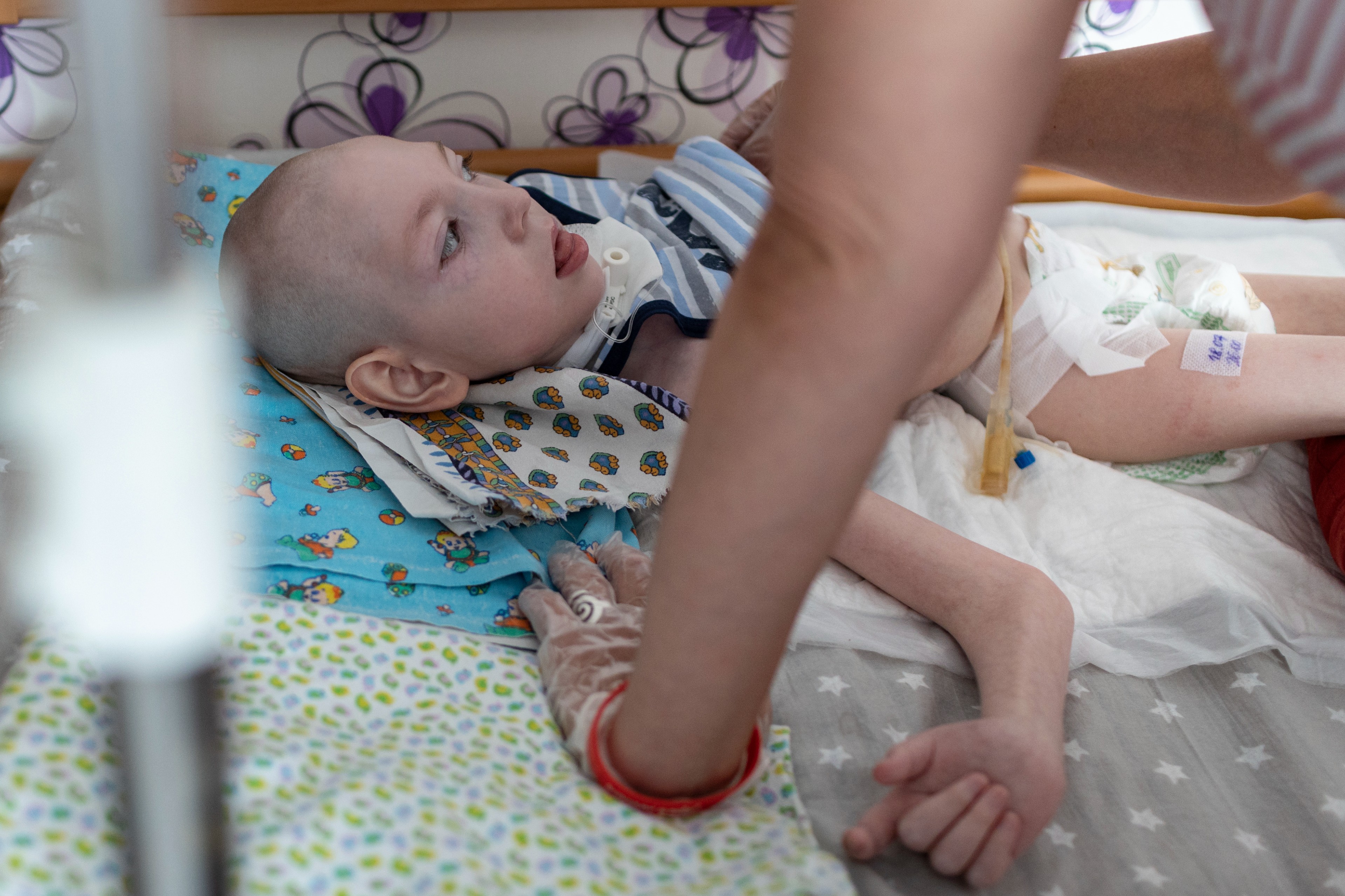 Arseniy Shestakov, an eight-year-old boy with severe cerebral palsy and epilepsy, at his home in Moscow.