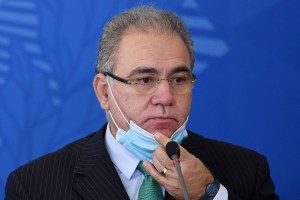 Brazilian Health Minister Marcelo Queiroga takes off his face mask during a press conference, after a meeting of the COVID-19 National Coordination Committee to Combat the Pandemic on April 14, 2021.