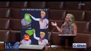 ​Georgia Republican Rep. Marjorie Taylor Greene gestures to the Scooby Doo meme she brought to Congress on Sept. 22, 2021.