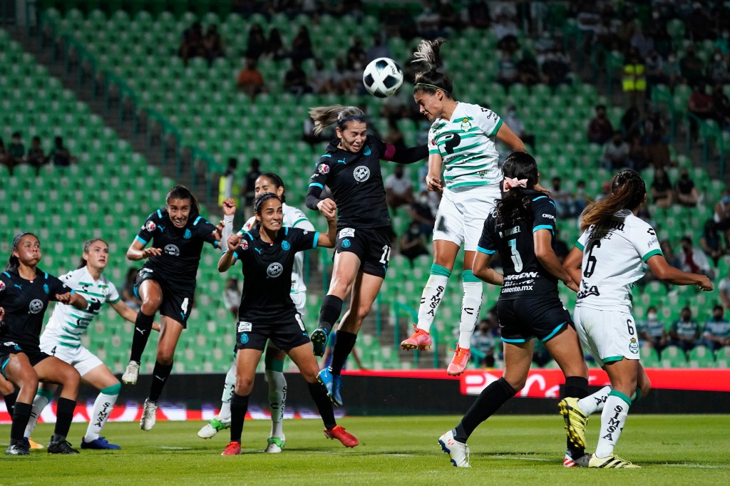 Alicia Cervantes (L) of Chivas fights for the ball with Alexxandra Ramirez (R) of Santos during a match between Santos and Chivas as part of the Torneo Grita Mexico A21 Liga MX Femenil at Corona Stadium on September 12, 2021 in Torreon, Mexico.